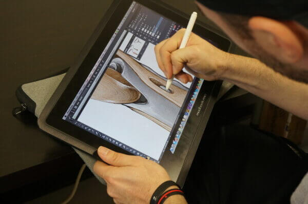 Hands sketching out a product design sketch