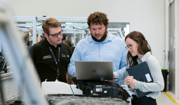 Kickr team members looking at the product development process on a computer screen