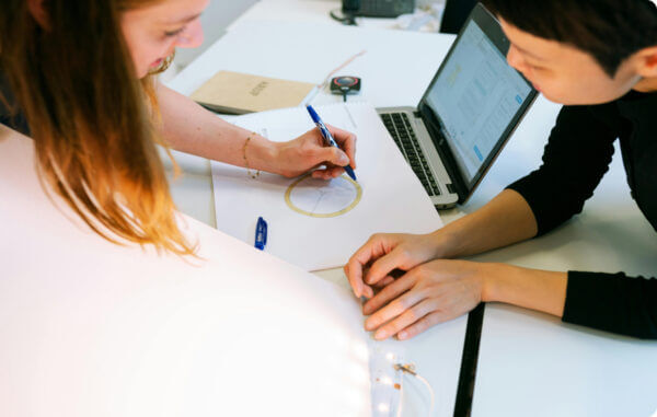 Group of engineers doing r&d product design on sketch paper