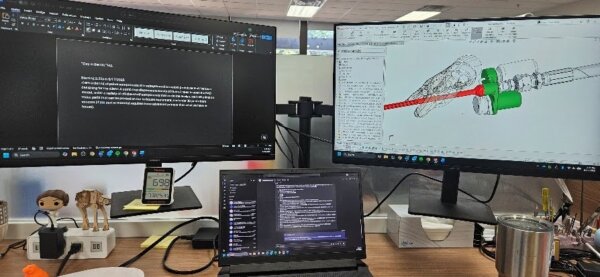 View of engineers desk with multiple computer screens during a product prototyping process