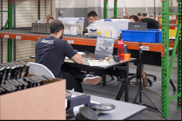 Men working at desks in a hardware accelerator